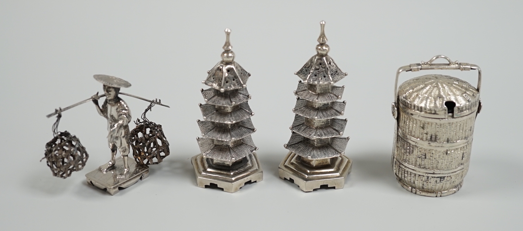 A Chinese white metal 'wedding basket' by Wang Hing, 63mm, a pair of similar white metal pagoda condiments, KSM and a figure.